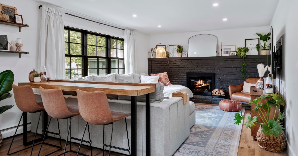 Family Room in renovated Bucks County home with dark painted brick fireplace