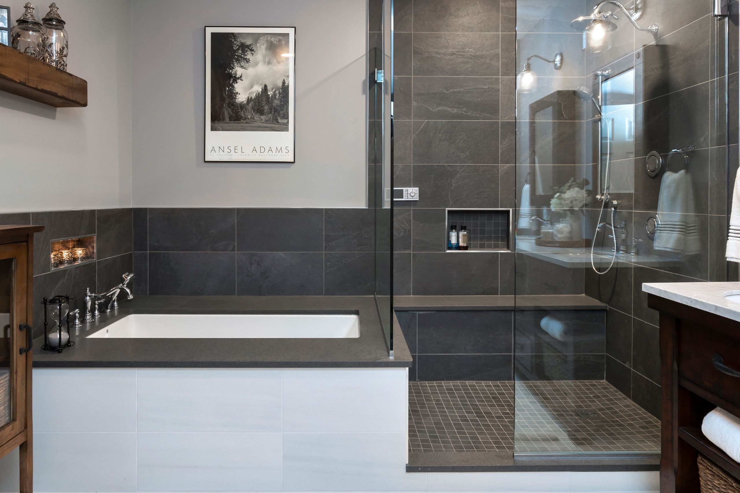 Black and white bathroom with tub and shower door