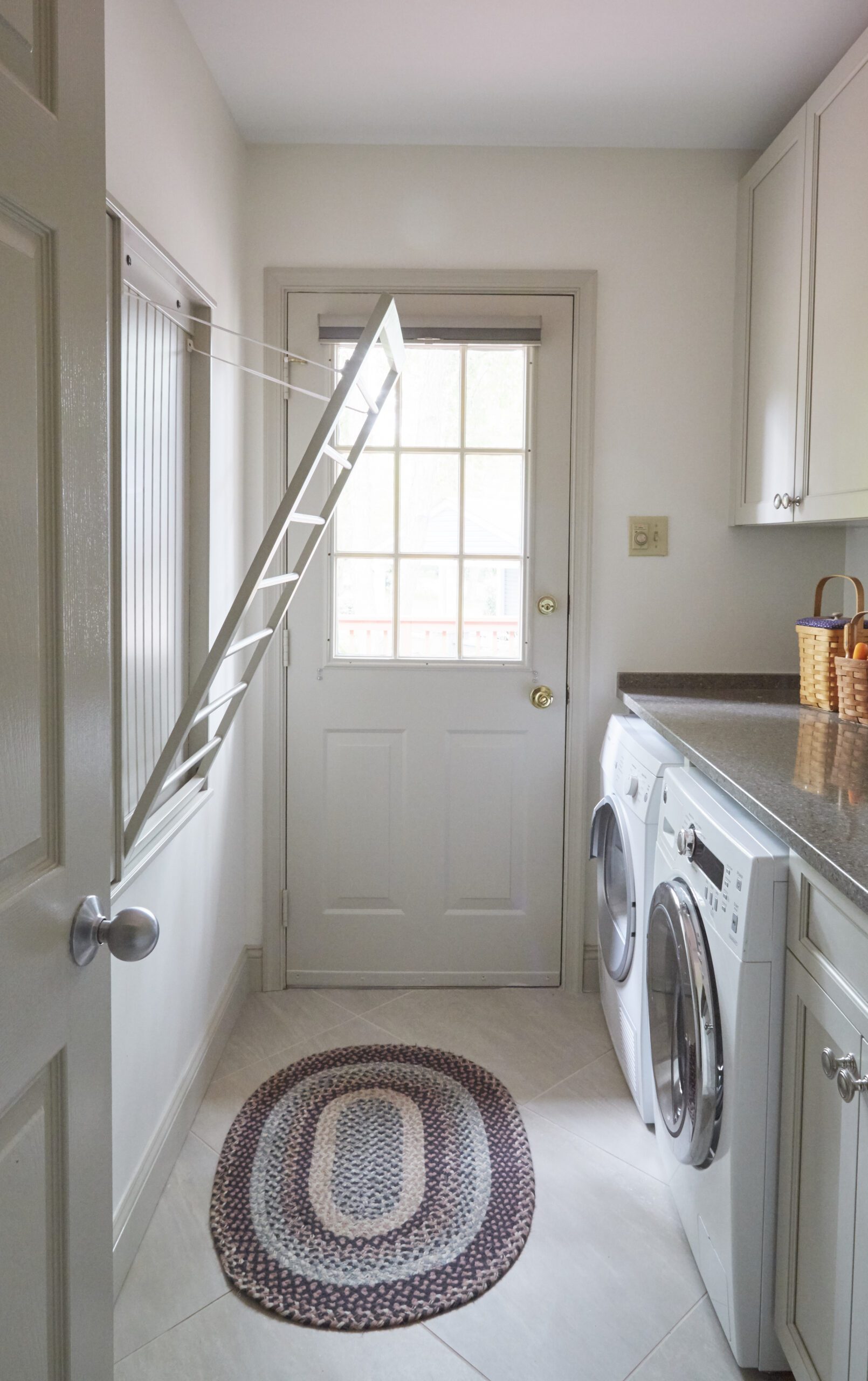 Remodeled laundry room with drying rack built in.