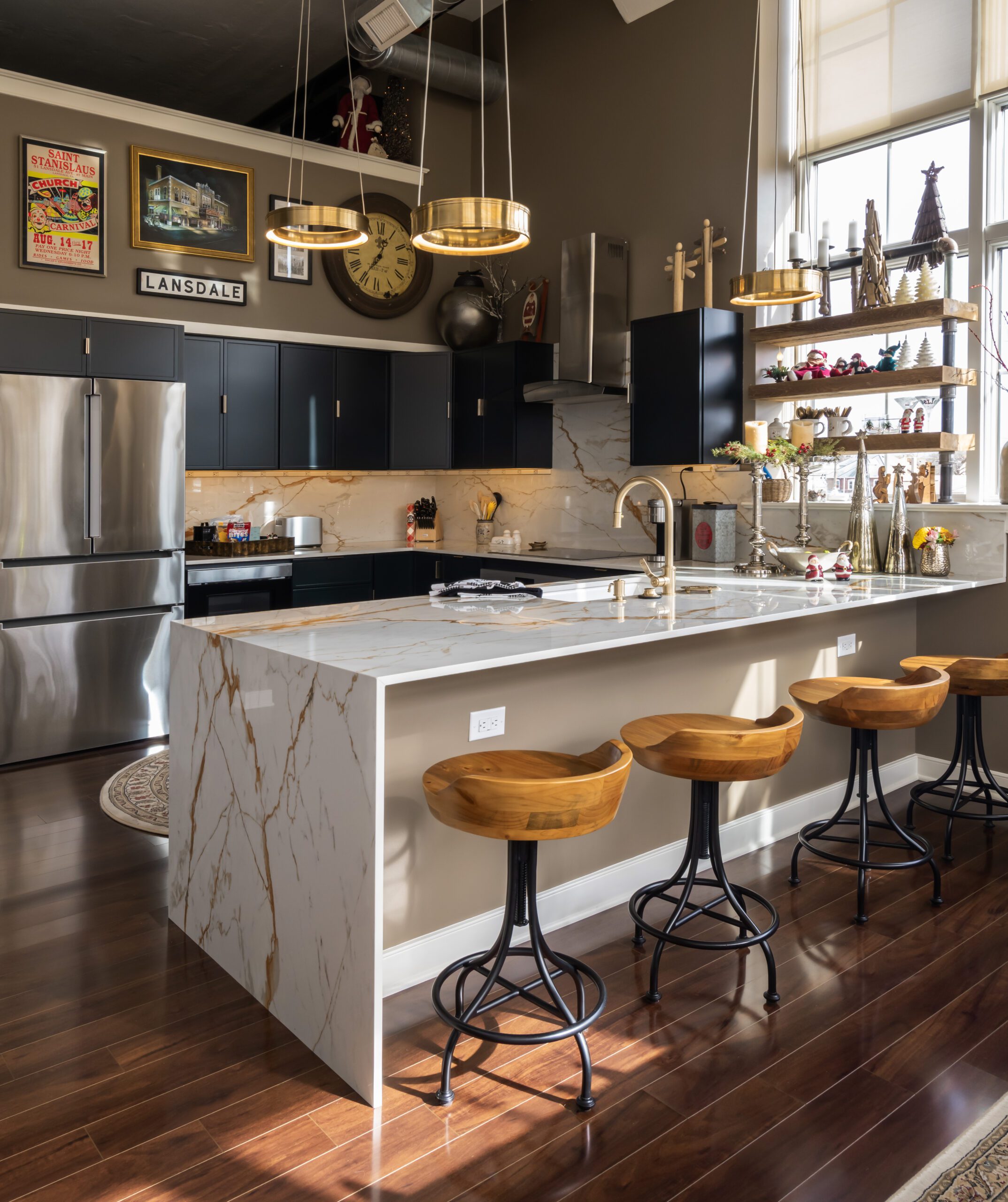 Waterfall countertops with stools in a remodeled kitchen
