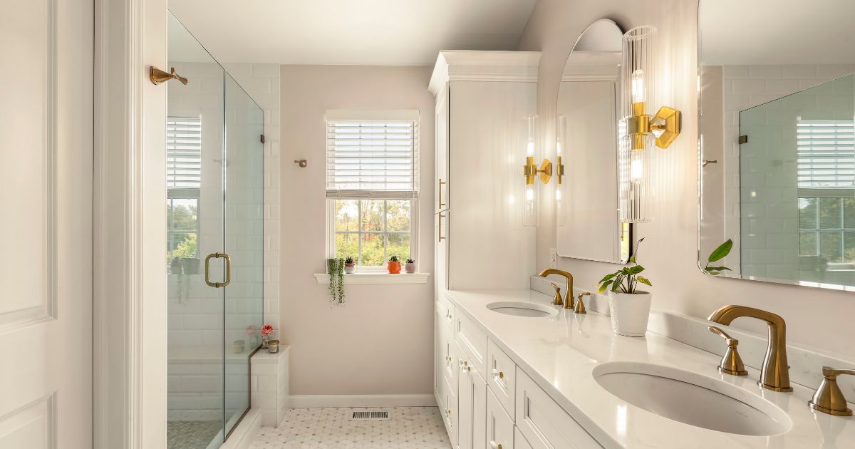 Remodeled bathroom with white cabinetry and double sink vanity.