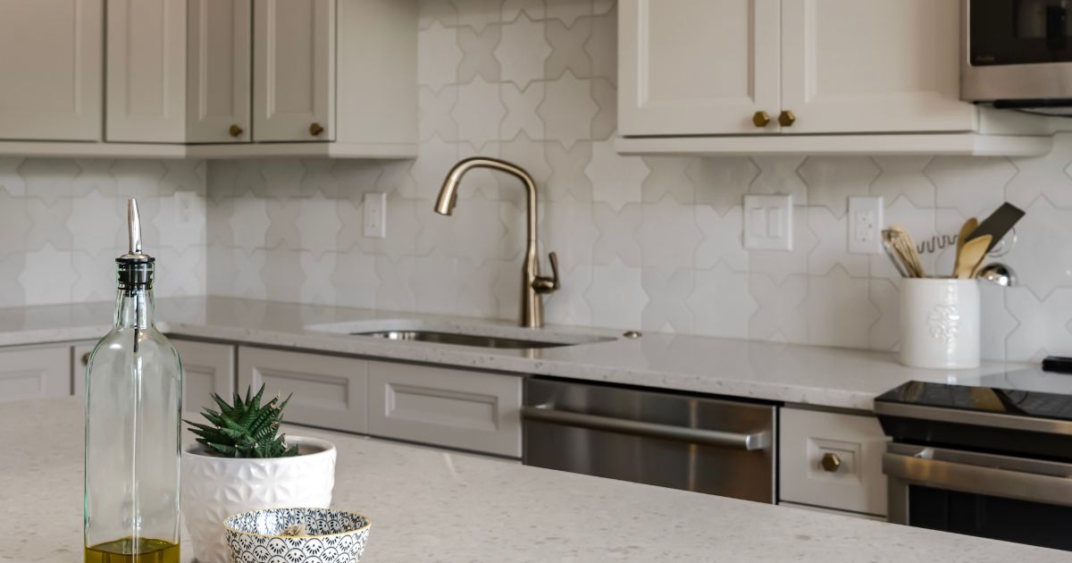 Remodeled kitchen with grey cabinets and white quartz cabinets