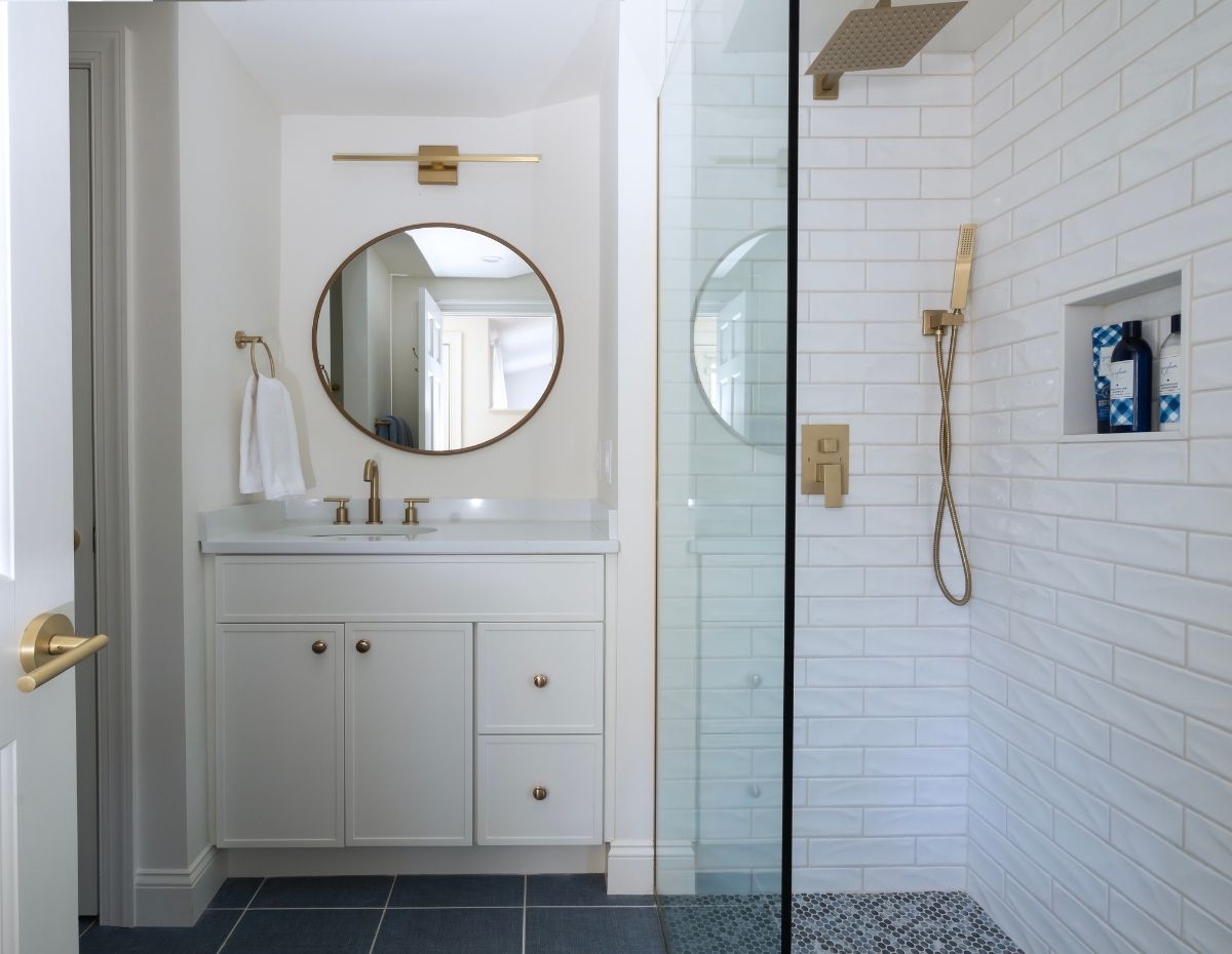 white subway tile bathroom with gold fixtures