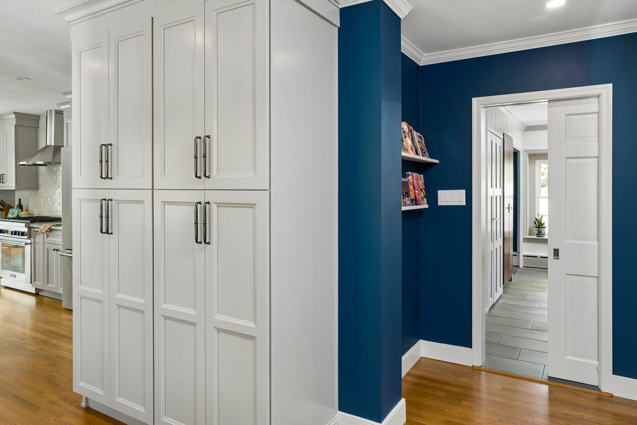 Pantry cabinetry in Rydal remodel home. Blue walls and hardwood floors