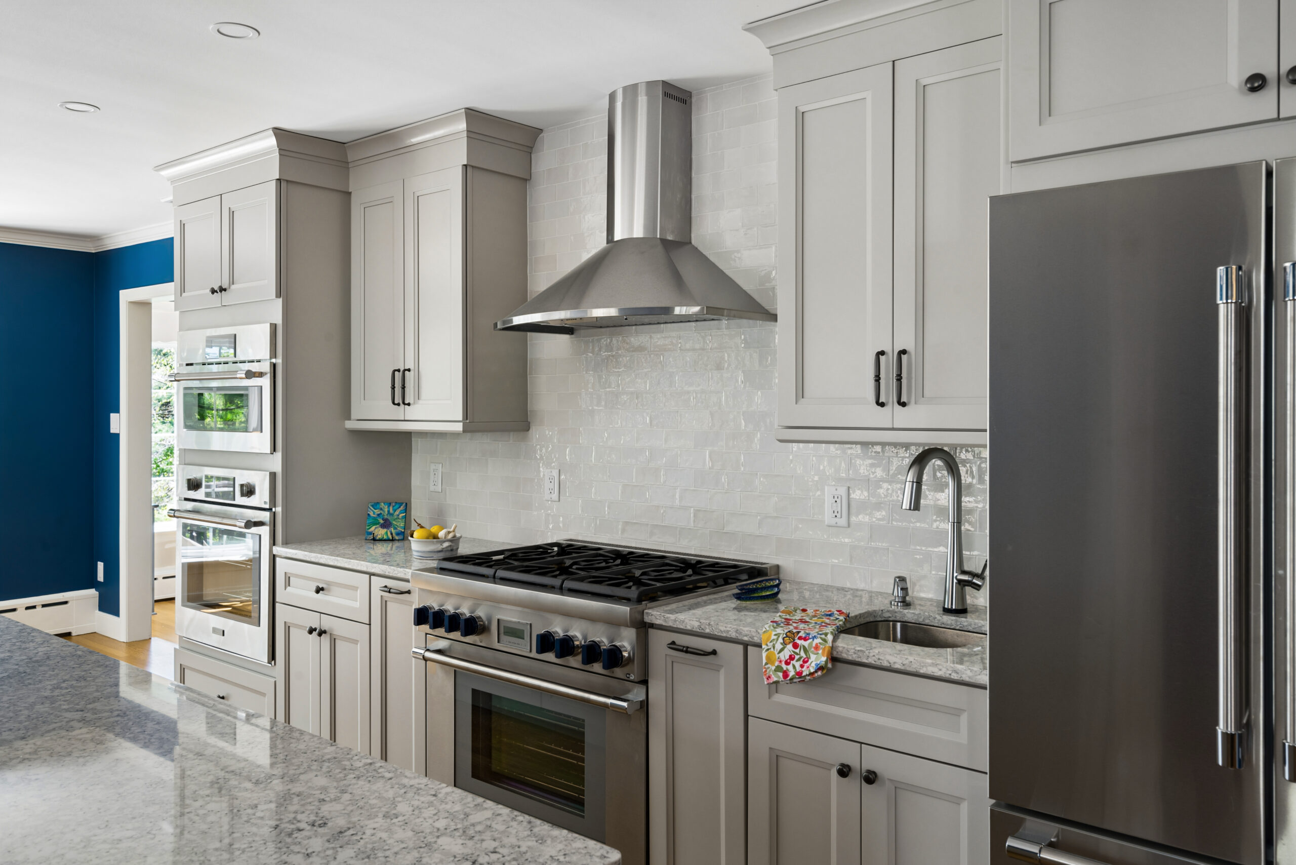 Rydal remodeled kitchen with stainless steel stove and wall ovens. Tile backsplash 