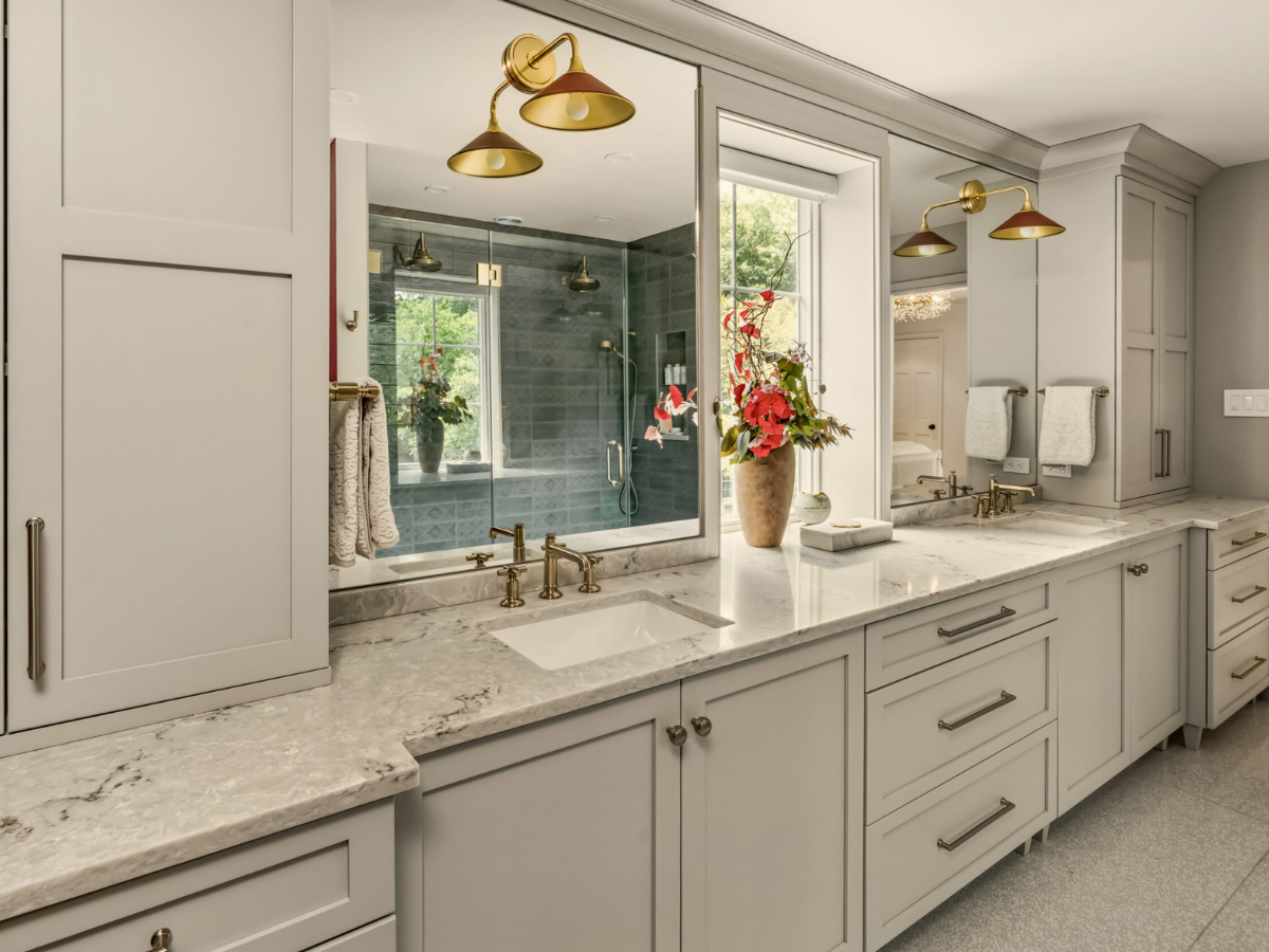 White cabinets and granite countertops in remodeled bathroom