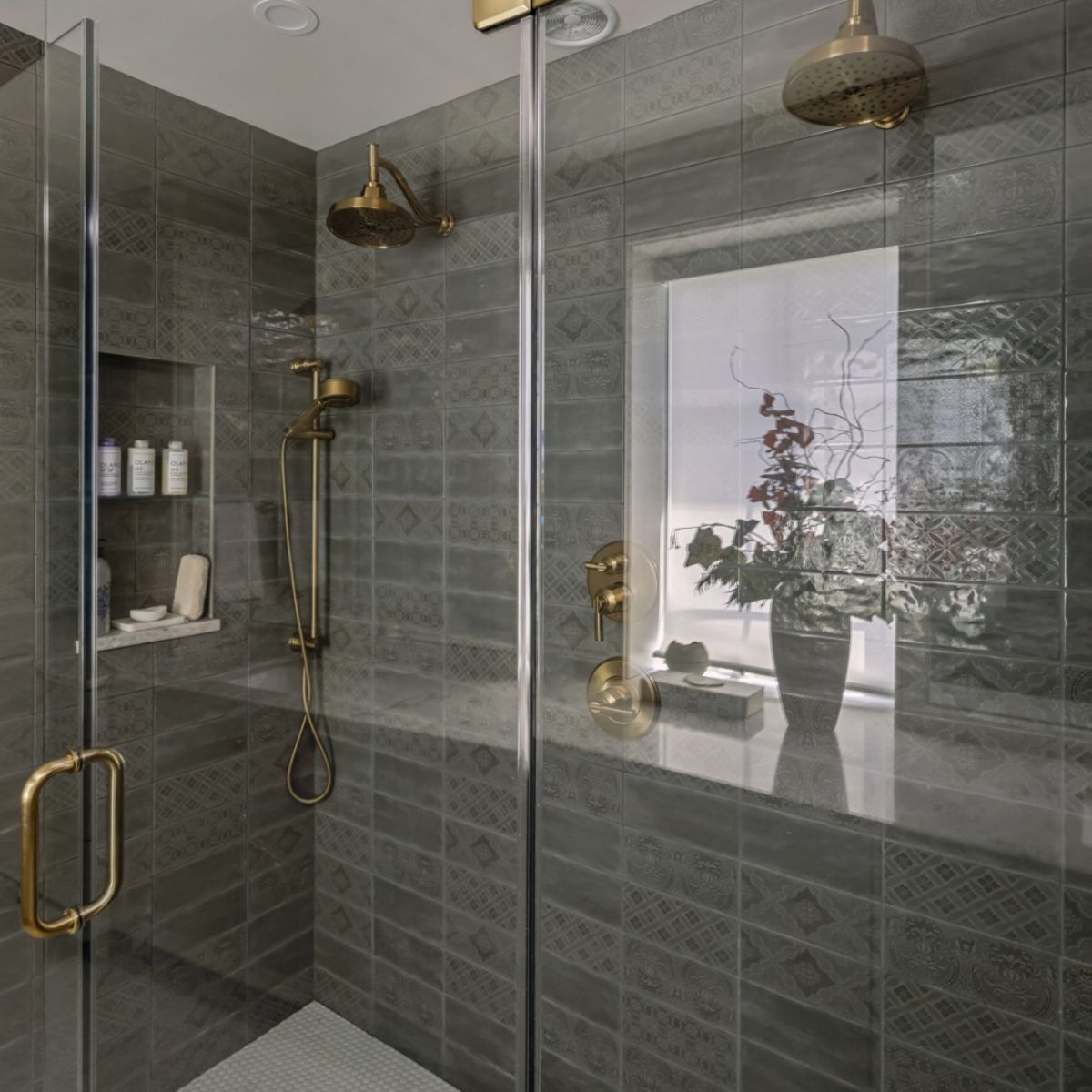 Shower with gray tiles and glass door