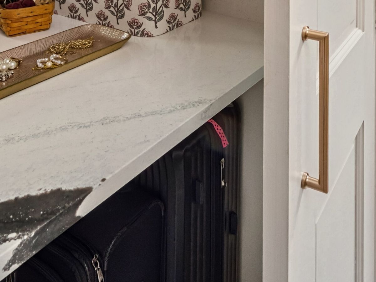 Granite counter top showing space underneath for luggage storage
